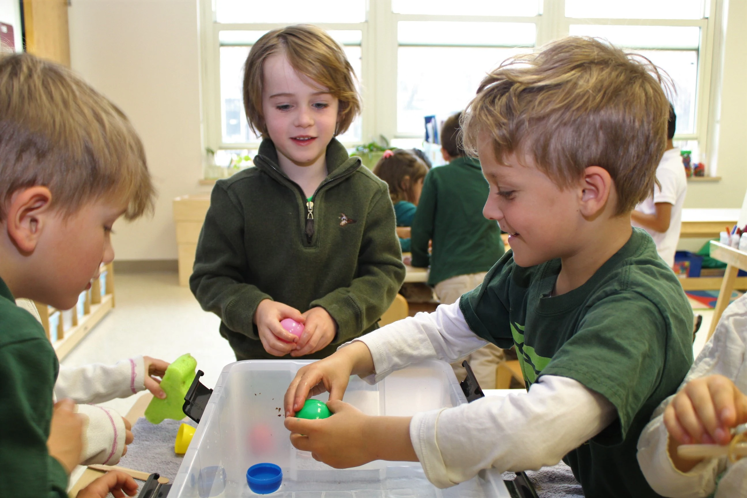 Brent students exploring objects in a tub of water